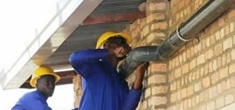 Workers installing pipework