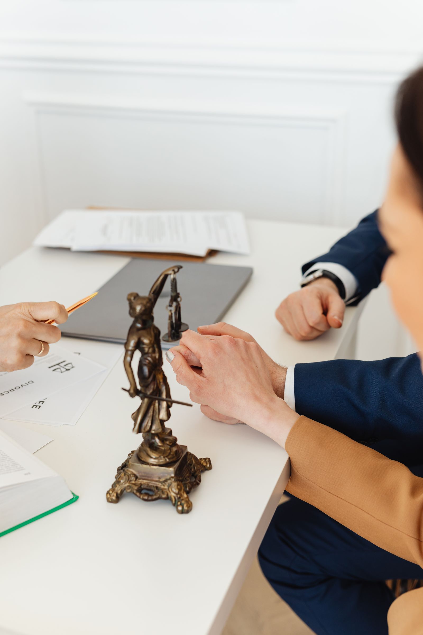 Legal consultation with documents and a justice statue